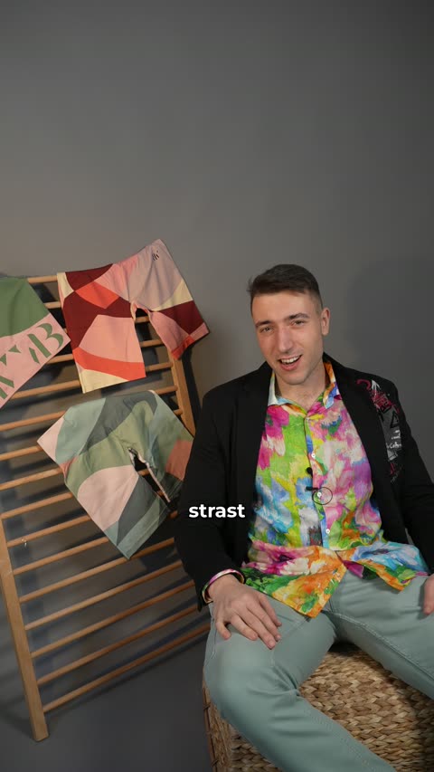 Žan Bassanese on a styled set for the NOTBW brand story, mid-laugh — on camera, mic on, exactly how the dataset gets made.
